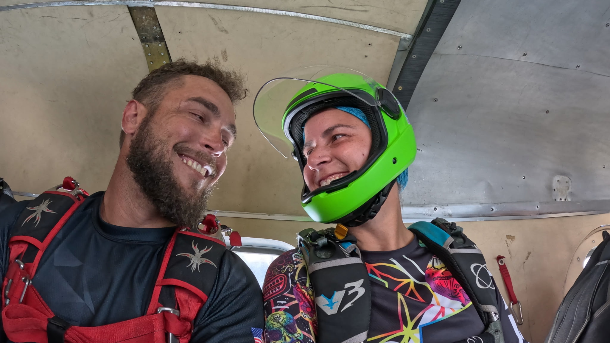 Felecia and AJ smiling together aboard a skydiving aircraft
